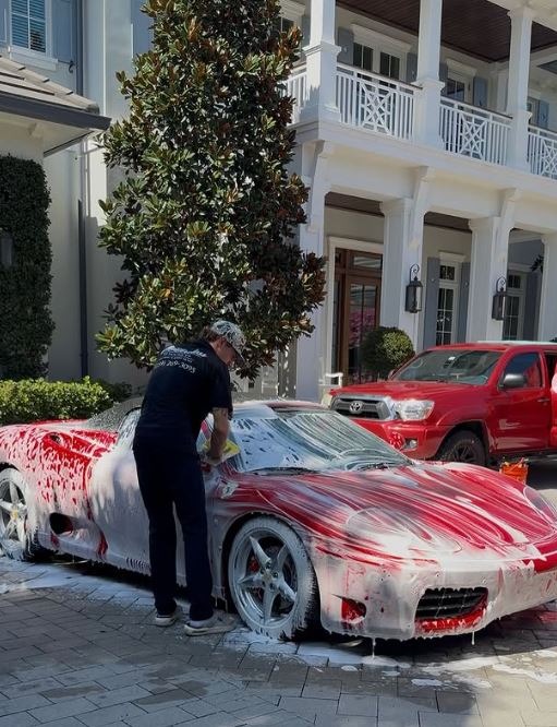 Technician polishing paintwork to remove swirls and haze on a luxury car